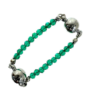 Close up of faceted emerald green crystals on a mini connector