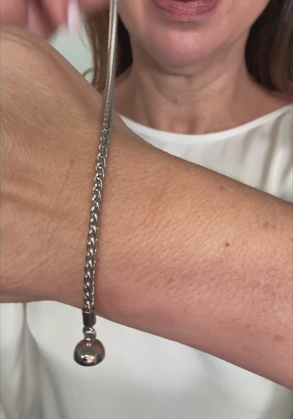 Maria Nicola: Stacks the wheat chain bracelets in silver, rose gold and gold on one wrist, then wears the short wheat chain at the base of the neck.