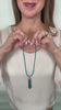 Maria styling tassels on their own and on her necklace